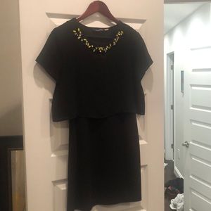 Little black dress with neck details.